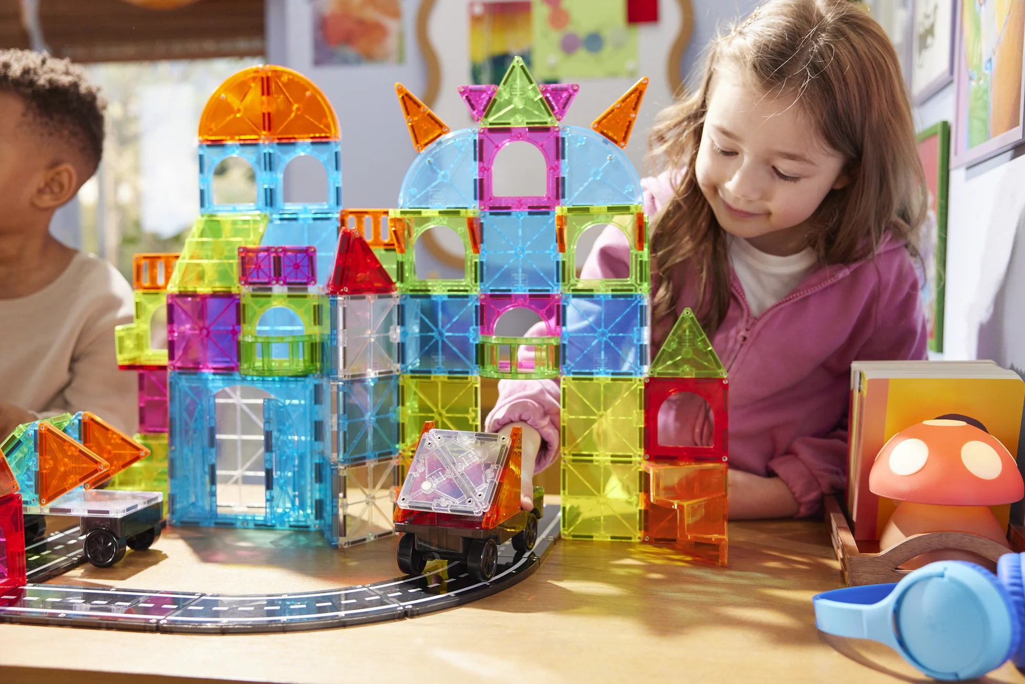 Children playing with colorful building blocks on a table